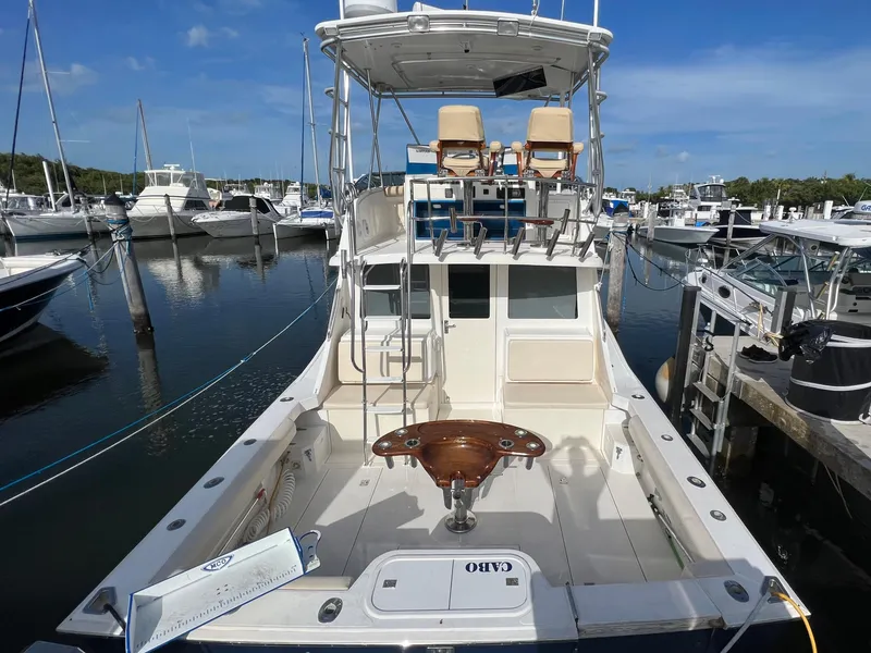 Slide: The Image of 2000 Cabo 35 Flybridge Sportfisher docked at a marina, rear view. - 3