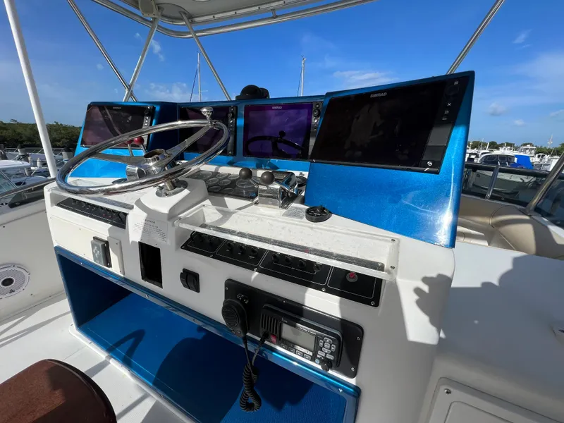 Slide: The Image of Helm of 2000 Cabo 35 Flybridge Sportfisher with modern navigation equipment. - 30