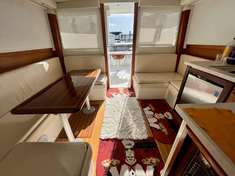 Slide: The Image of Interior of 2000 Cabo 35 Flybridge Sportfisher with seating, table, and kitchenette. - 34