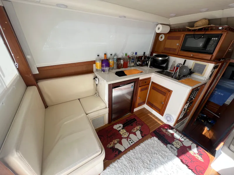 Slide: The Image of Interior of 2000 Cabo 35 Flybridge Sportfisher with kitchenette and seating area. - 36