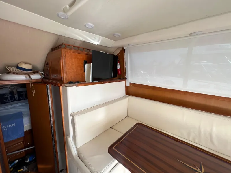Slide: The Image of Interior of 2000 Cabo 35 Flybridge Sportfisher with seating and wooden table. - 40