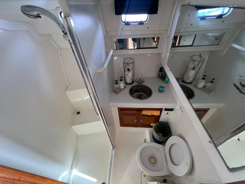 Slide: The Image of 2000 Cabo 35 Flybridge Sportfisher bathroom with shower, sink, and toilet. - 42