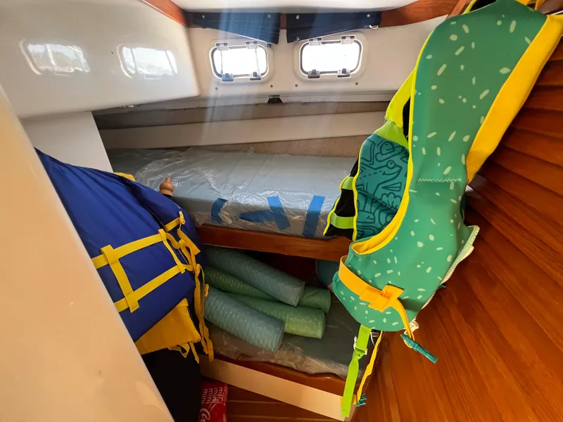 Slide: The Image of Interior cabin of 2000 Cabo 35 Flybridge Sportfisher with life jackets and foam noodles. - 43