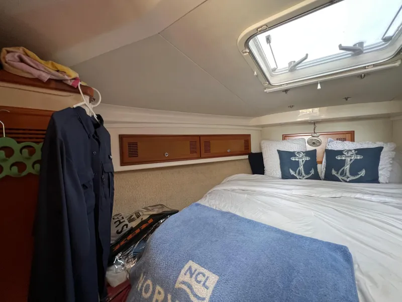 Slide: The Image of Cozy cabin interior of a 2000 Cabo 35 Flybridge Sportfisher with nautical-themed decor. - 47