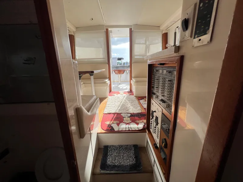 Slide: The Image of Interior of 2000 Cabo 35 Flybridge Sportfisher boat with control panel and seating area. - 48