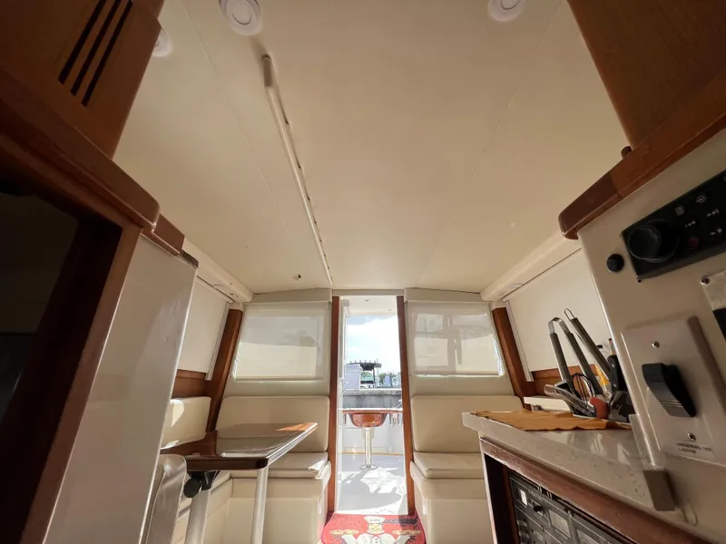 Slide: The Image of Interior of 2000 Cabo 35 Flybridge Sportfisher boat with seating and kitchen area. - 49