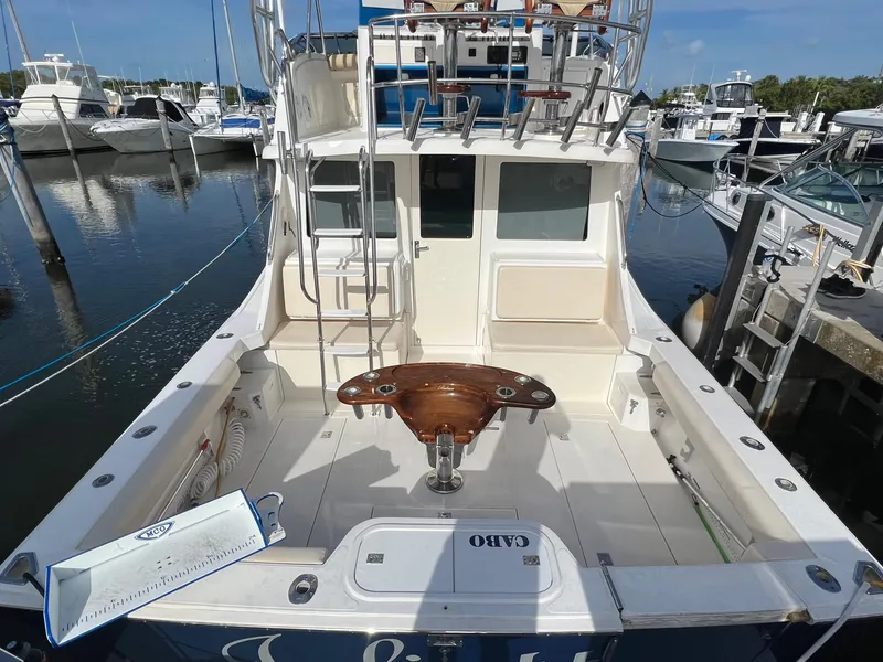 Slide: The Image of 2000 Cabo 35 Flybridge Sportfisher boat docked at marina, rear view. - 5