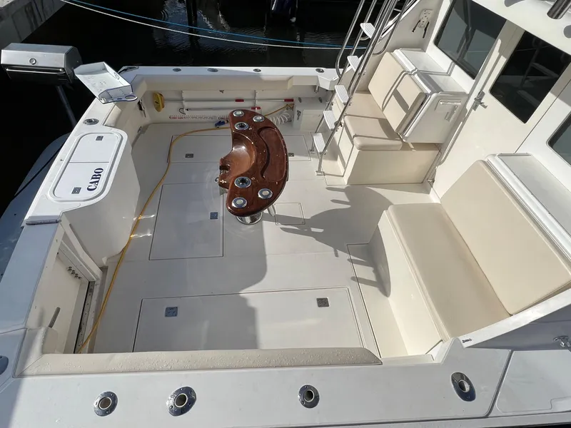 Slide: The Image of 2000 Cabo 35 Flybridge Sportfisher boat deck with seating and fishing rod holders. - 6