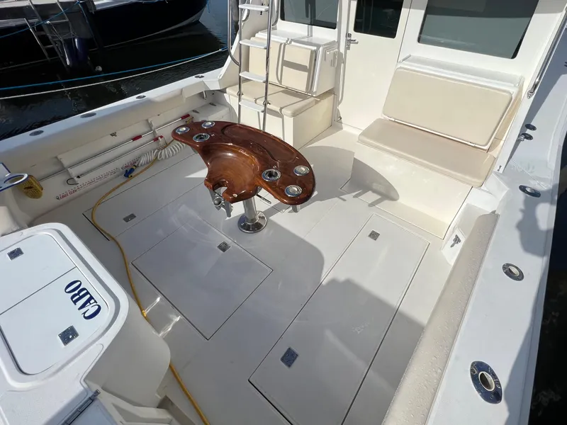 Slide: The Image of 2000 Cabo 35 Flybridge Sportfisher cockpit with seating and fishing rod holders. - 7