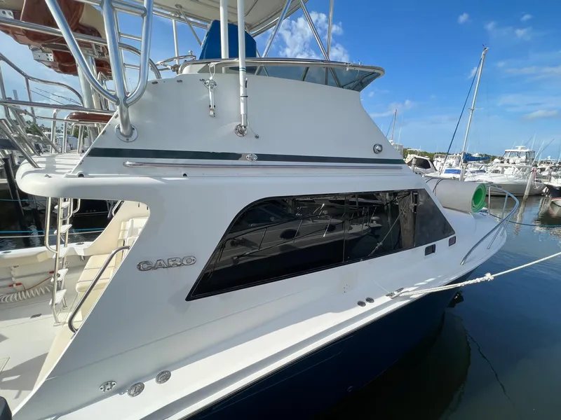 Slide: The Image of 2000 Cabo 35 Flybridge Sportfisher docked at a marina on a sunny day. - 8