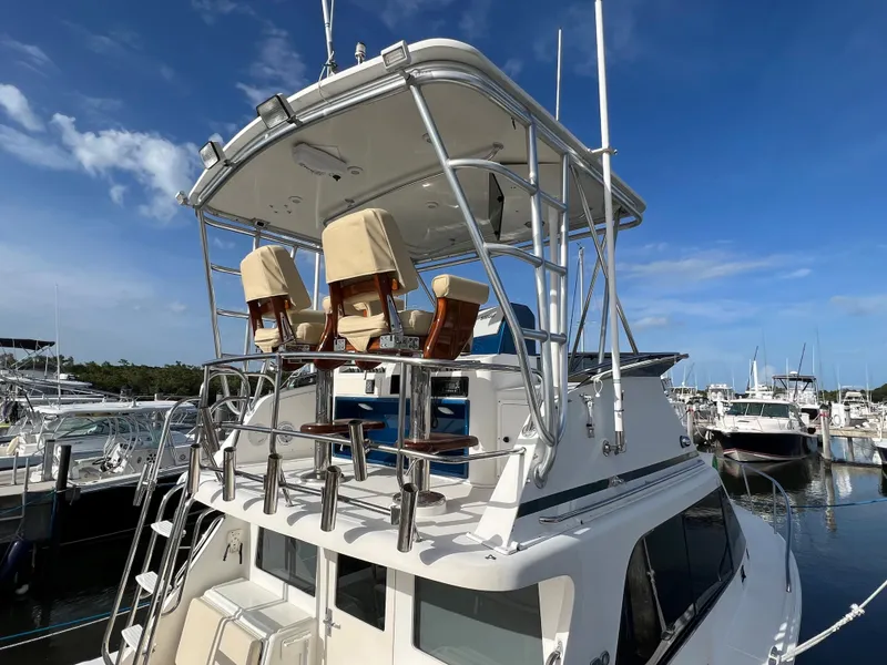 Slide: The Image of 2000 Cabo 35 Flybridge Sportfisher at marina, rear view of flybridge and seating. - 9