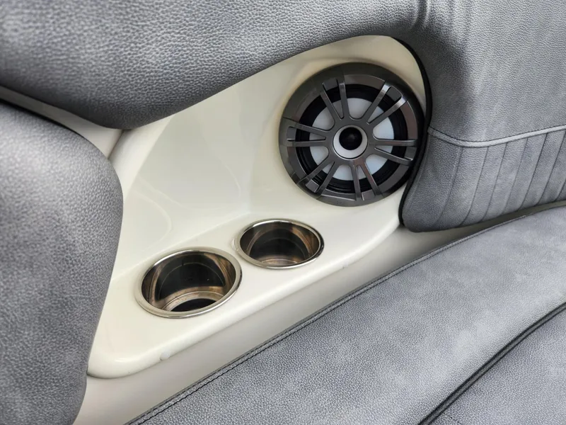 Slide: The Image of 2022 Stingray 231 DC boat interior with speaker and cup holders. - 16