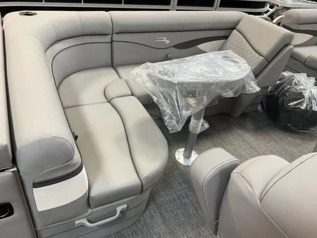 Slide: The Image of 2025 Bennington 20 SVL pontoon boat interior with gray seating and table. - 11