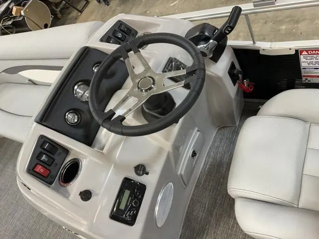 Slide: The Image of 2025 Bennington 20 SVL boat dashboard with steering wheel and controls. - 12