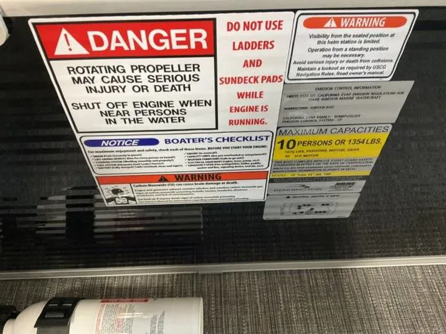 Slide: The Image of Warning labels on a 2025 Bennington 20 SVL boat, highlighting safety precautions and capacity limits. - 13