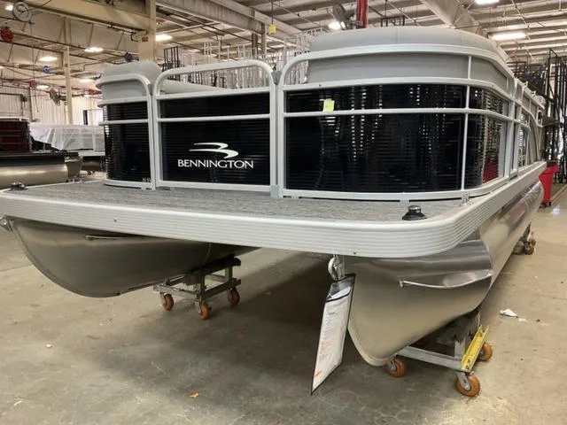 Slide: The Image of 2025 Bennington 20 SVL pontoon boat in a warehouse setting. - 3