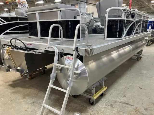 Slide: The Image of 2025 Bennington 20 SVL pontoon boat in a warehouse setting with a ladder attached. - 4