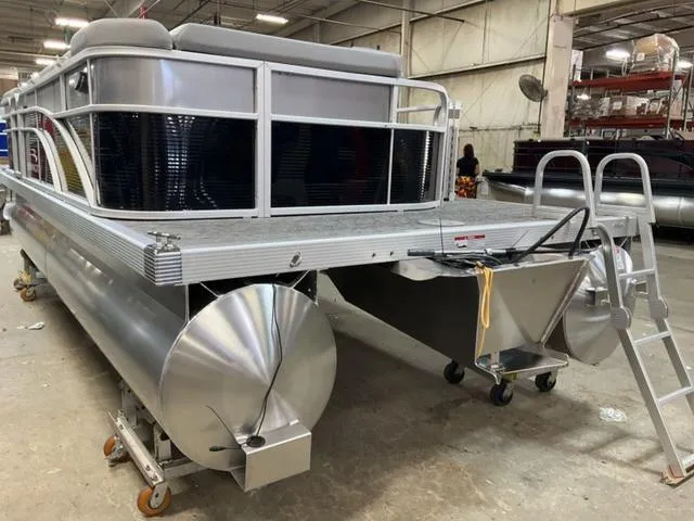Slide: The Image of 2025 Bennington 20 SVL pontoon boat in a warehouse setting. - 6