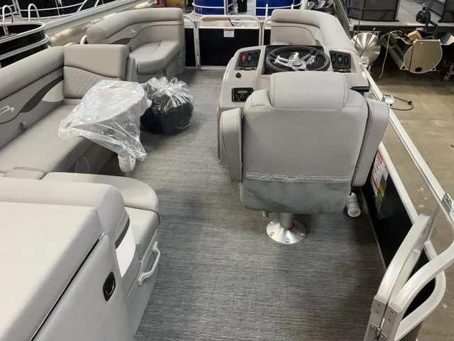 Slide: The Image of 2025 Bennington 20 SVL pontoon boat interior with gray seating and steering console. - 8