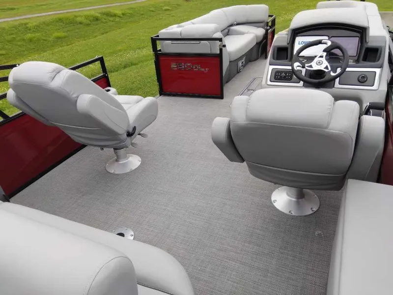 Slide: The Image of 2024 Regency 250 DL3 pontoon boat interior with gray seating and steering console. - 4
