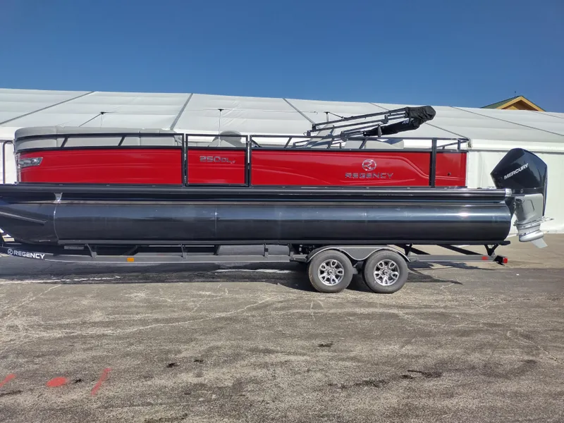 The Image of 2024 Regency 250 DL3 pontoon boat on a trailer, red and black exterior. - 0