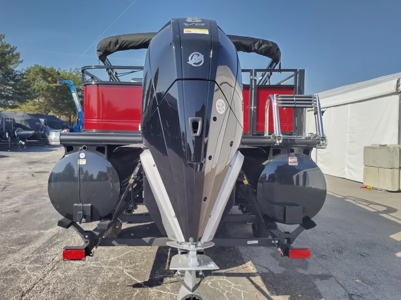 Slide: The Image of 2024 Regency 250 DL3 pontoon boat rear view with powerful outboard motor. - 3