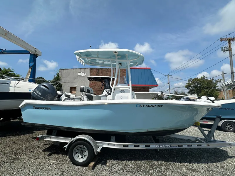The Image of 2022 Tidewater 198 CC boat on a trailer in a marina. - 1