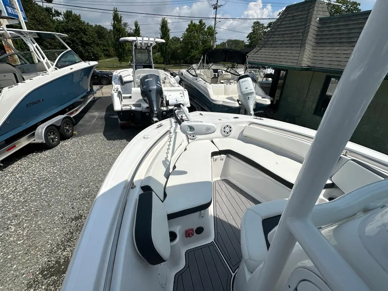 Slide: The Image of 2022 Tidewater 198 CC boat on display at a dealership, surrounded by other boats. - 11