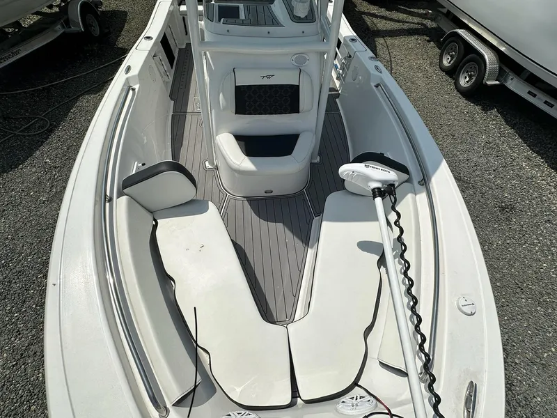 Slide: The Image of 2022 Tidewater 198 CC boat interior with seating and trolling motor. - 14