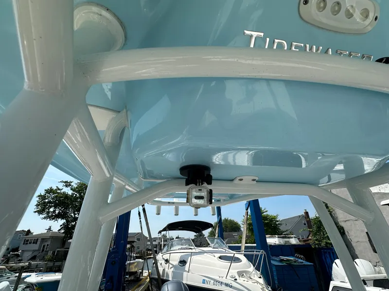 Slide: The Image of 2022 Tidewater 198 CC boat under a blue canopy. - 15