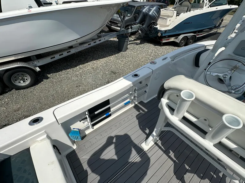 Slide: The Image of 2022 Tidewater 198 CC boat interior with rod holders and storage compartments. - 5