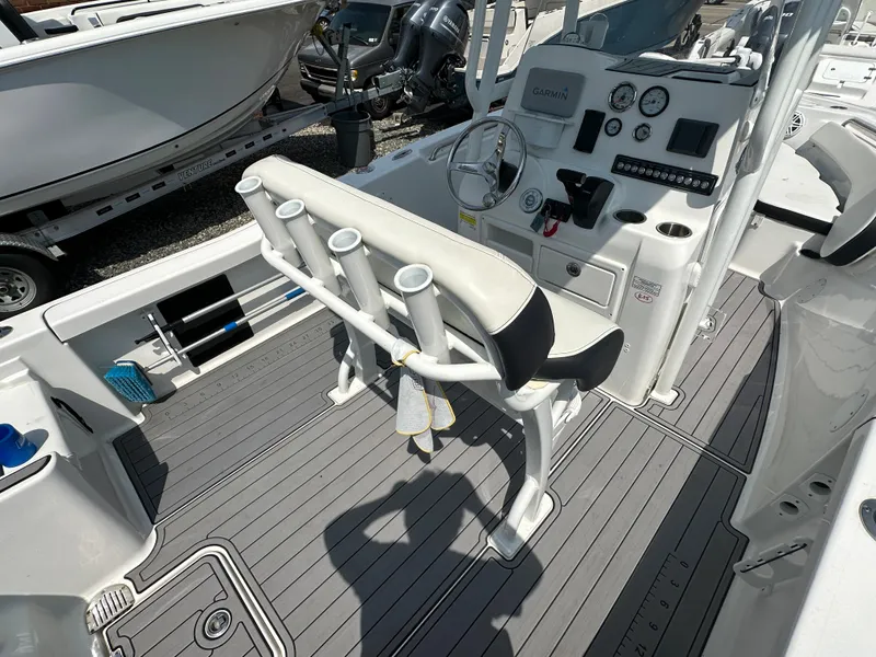 Slide: The Image of 2022 Tidewater 198 CC boat interior with helm and rod holders. - 7