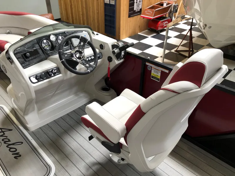 Slide: The Image of 2023 Avalon LSZ 2385 Cruise Rear Bench boat interior with steering console and captain's chair. - 10