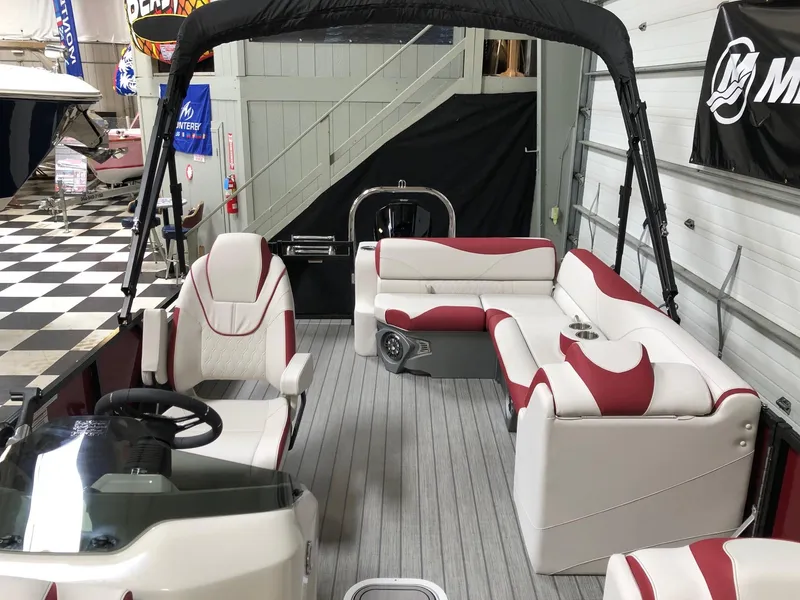 Slide: The Image of 2023 Avalon LSZ 2385 Cruise Rear Bench pontoon boat with red and white seating in showroom. - 14