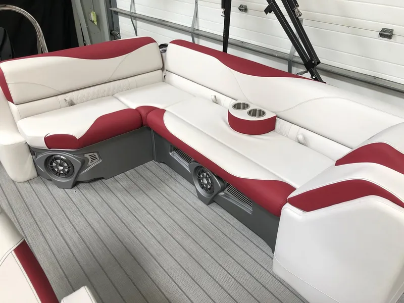 Slide: The Image of 2023 Avalon LSZ 2385 Cruise Rear Bench with red and white seating, cup holders, and speakers. - 9