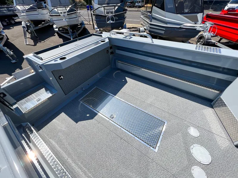 Slide: The Image of 2023 Hewescraft 240 Ocean Pro HT boat interior, featuring spacious deck and storage compartments. - 14