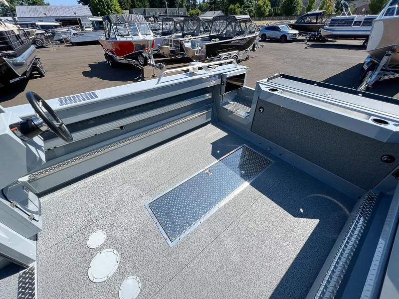 Slide: The Image of 2023 Hewescraft 240 Ocean Pro HT boat interior, spacious deck, steering wheel, and storage compartments. - 15