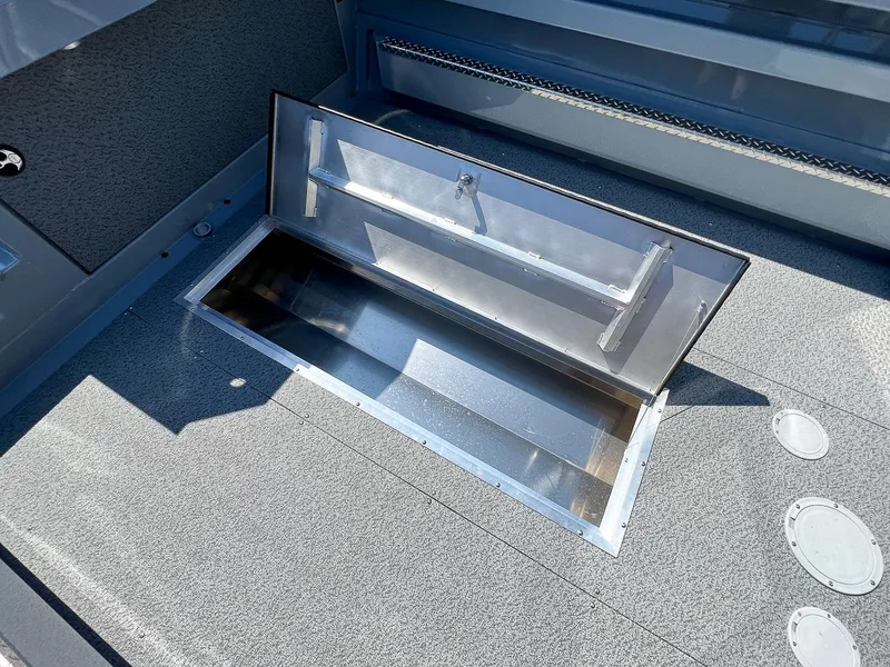 Slide: The Image of Open storage compartment on 2023 Hewescraft 240 Ocean Pro HT boat. - 16