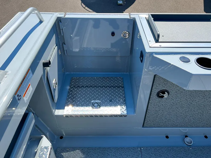 Slide: The Image of 2023 Hewescraft 240 Ocean Pro HT boat interior with storage compartments and diamond plate flooring. - 19