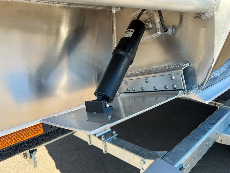 Slide: The Image of Close-up of 2023 Hewescraft 240 Ocean Pro HT trim tab and actuator. - 21