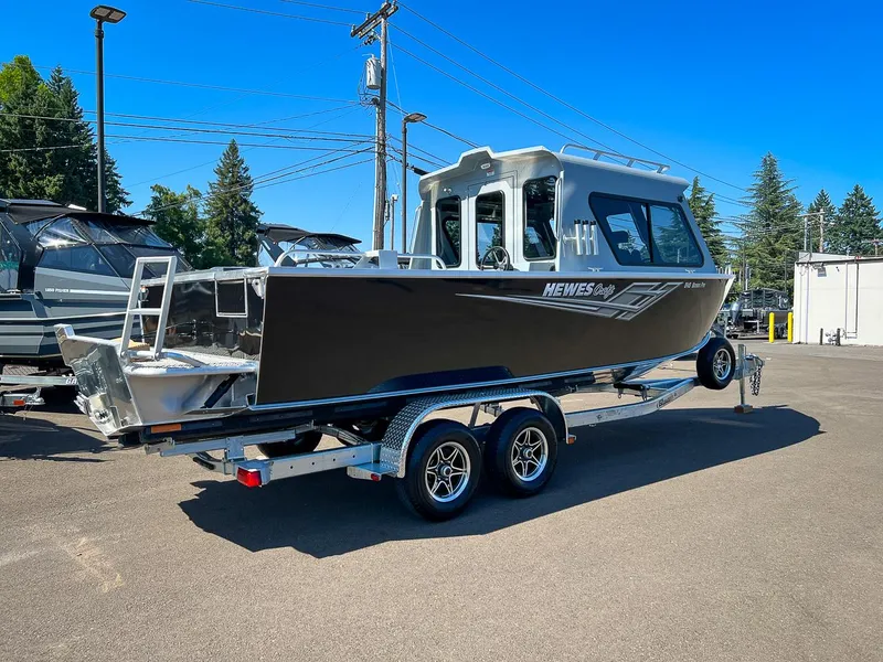 Slide: The Image of 2023 Hewescraft 240 Ocean Pro HT boat on a trailer in a parking lot. - 3