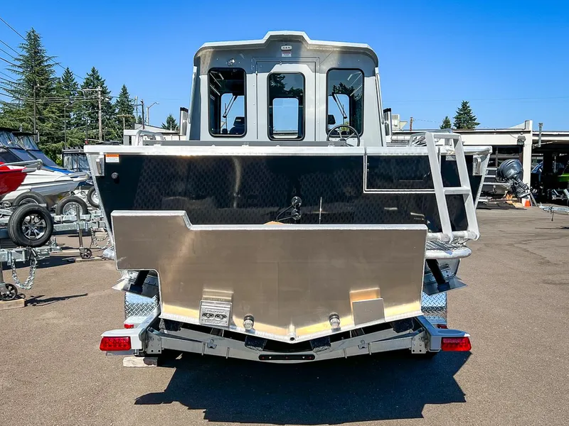 Slide: The Image of 2023 Hewescraft 240 Ocean Pro HT boat rear view at a dealership. - 4