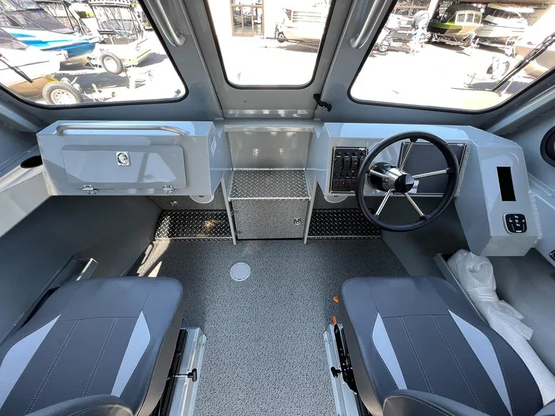 Slide: The Image of 2023 Hewescraft 240 Ocean Pro HT interior cockpit with steering wheel and seating. - 9
