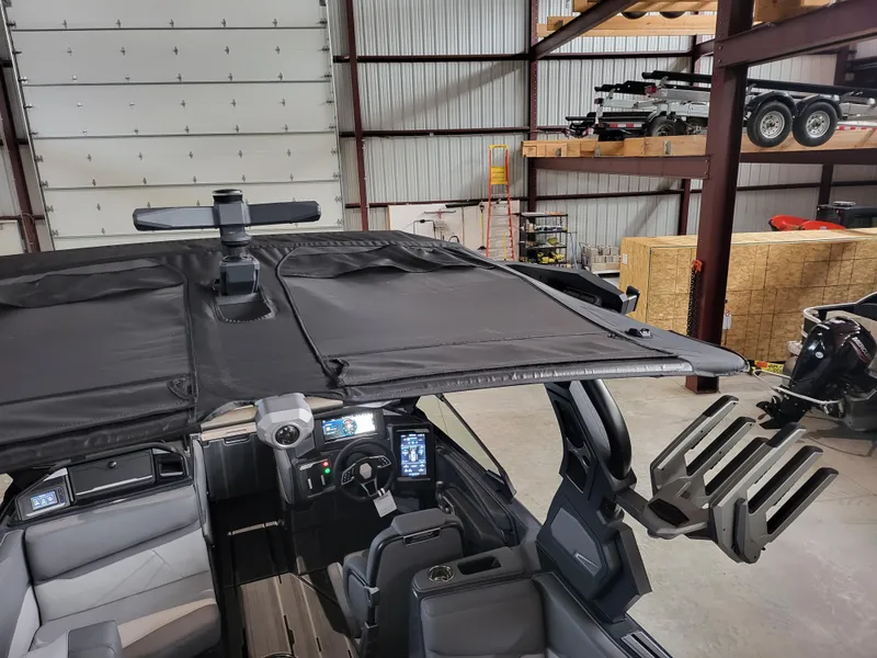 Slide: The Image of 2024 Supra SL boat interior with advanced dashboard and seating in a warehouse setting. - 10