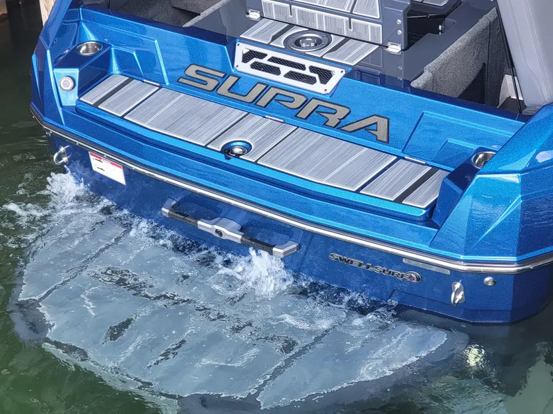 Slide: The Image of 2024 Supra SL boat with blue exterior, partially submerged in water. - 22