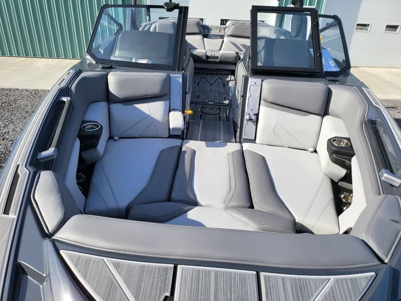 Slide: The Image of 2024 Supra SL boat interior with gray seating and cup holders. - 26