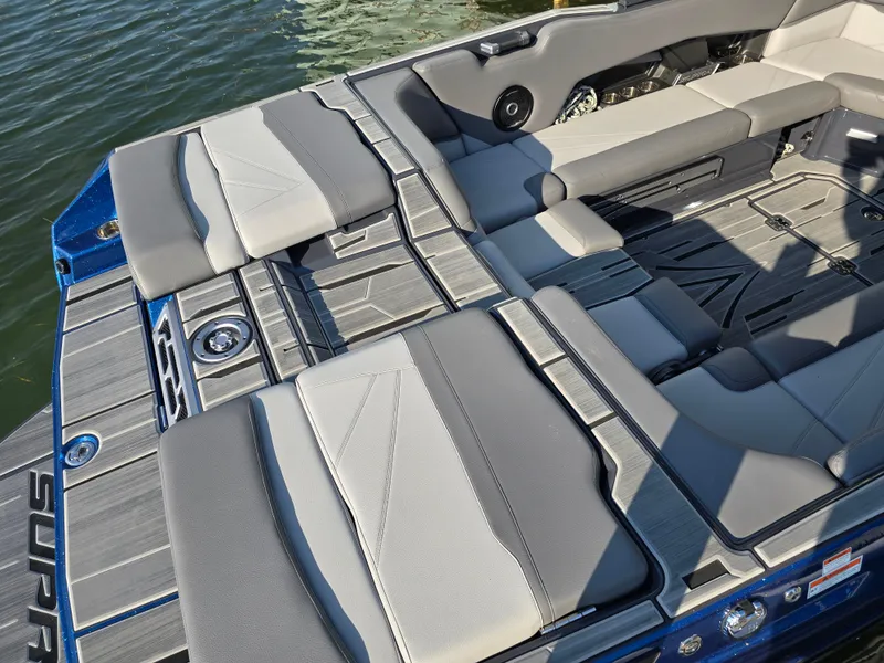 Slide: The Image of 2024 Supra SL boat interior with sleek gray seating and modern design on the water. - 36