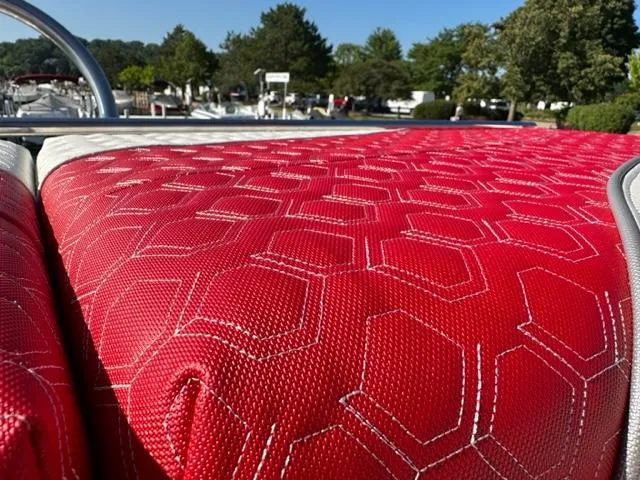 Slide: The Image of Close-up of red hexagonal-patterned upholstery on 2023 JC SportToon 24 TT boat. - 28