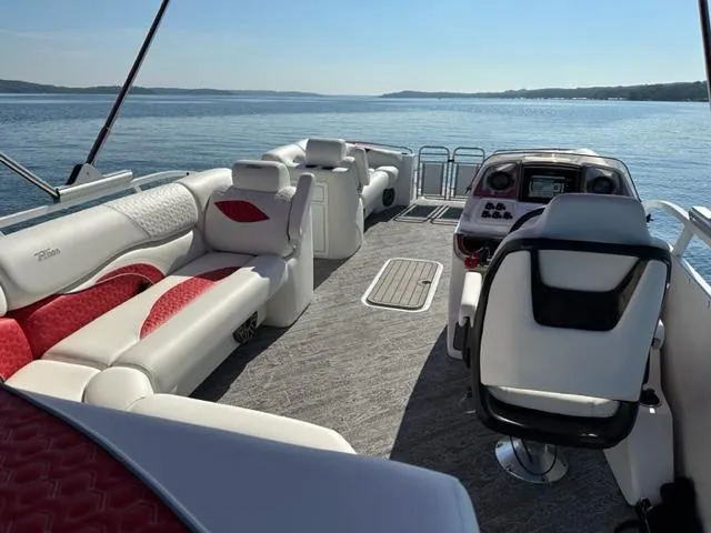 Slide: The Image of 2023 JC SportToon 24 TT pontoon boat with luxurious seating on a serene lake. - 4