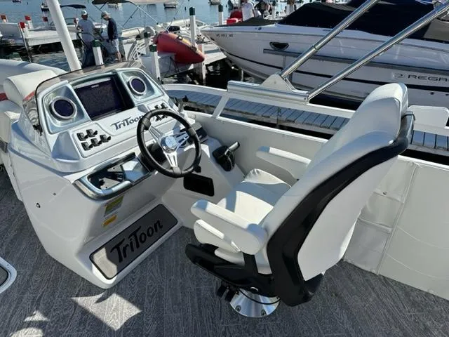 Slide: The Image of 2023 JC SportToon 24 TT boat helm with steering wheel and control panel. - 6
